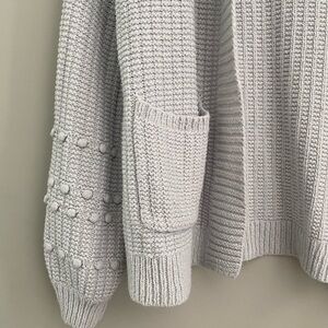 Light grey cardigan with bubble design on sleeves